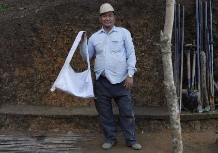 Ziona, 67, takes a break at the construction site of a church